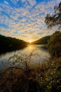 Golden sunbeams spread across the lake, dramatically surrounded by clouds, summer, Rursee, Obersee,