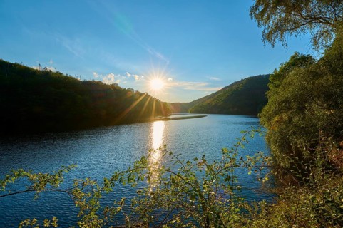 Sunset reflected in the lake, surrounded by forest and hills, summer, Rursee, Obersee, Simmerath,