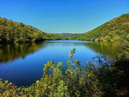 A quiet lake, surrounded by hills and forests under a blue sky, summer, Rursee, Obersee, Simmerath,
