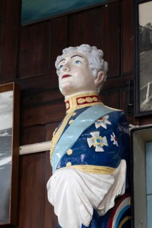 Interior of historic The Sailors Reading Room, Southwold, Suffolk, England, UK - figurehead of King