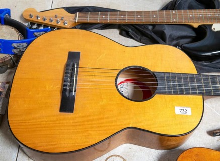 Acoustic guitar viewed from above on display at auction, UK