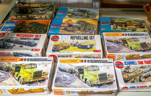 Boxes of Matchbox and Airfix military vehicles scale models on display at auction, UK