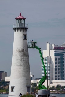 Detroit, Michigan - A worker on a lift paints the Milliken State Park Lighthouse. The lighthouse is