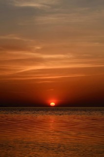 Fireball... Sunset over the Wadden Sea near Duhnen, Cuxhaven, North Sea, glowing red setting sun,