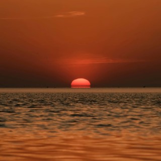 When the red sun sinks into the sea... Cuxhaven, North Sea, sunset in calm weather, glowing red