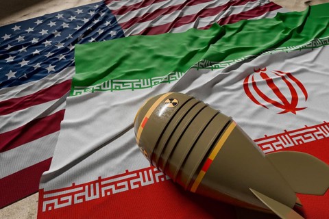 Nuclear bomb, american and Iranian flags resting on desert sand