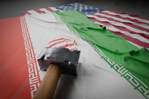 Large hammer resting on american and Iranian flags