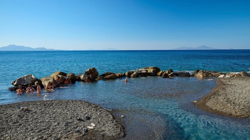 Rocks in clear blue sea, calm coastal landscape in sunshine, Embros Thermal Baths, Kos, Dodecanese,