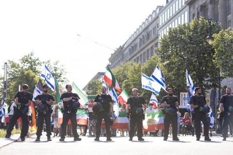 Police officers protect a pro-Israeli counter-protest with about 120 participants on the street