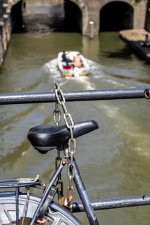 Cycling in the Netherlands, Utrecht, bicycle secured with a chain of steel links on a bridge over a