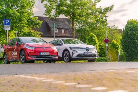 Two electric cars parked under trees in a quiet residential street, Deer E, car sharing, electric