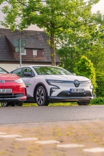 Two cars parked in front of a house in a green, quiet residential area, Deer E, car sharing,