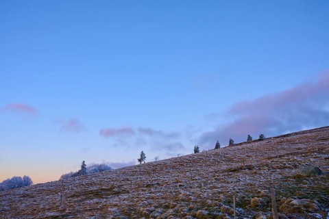 Hill scene with clear evening sky, calm and minimalistic, winter, Route de Cretes, Hohneck, La