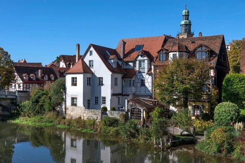 Old town houses located on the Pegnitz, behind the tower of St. John's Church, Lauf an der Pegnitz,