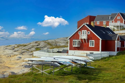 Typical architecture of Greenland Ilulissat with colored houses located near fjords and icebergs