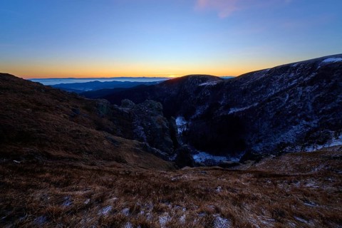 First rays of light over mountain peaks, cool morning with purple sky, view of the Rhine Valley,