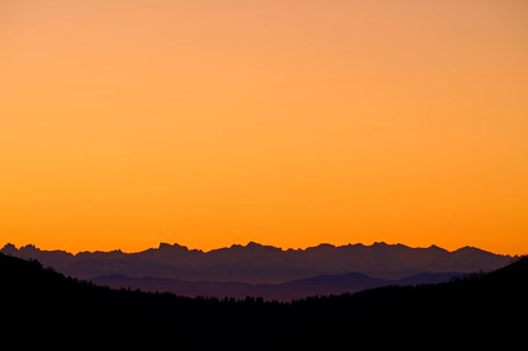 Mountain silhouette at sunrise with orange sky, looking at Alps, Hohneck, La Bresse, Vosges, France