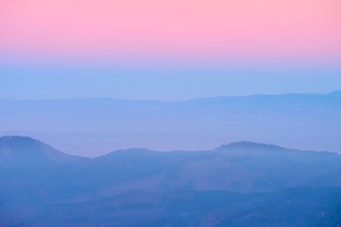 Foggy mountains spreading out under a pink sky, sunset, looking towards the Rhine Valley, Hohneck,