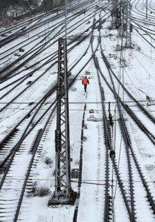 Railway workers between many tracks in winter, train formation in the Vorhalle district,