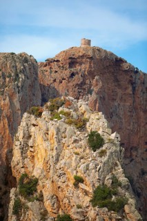 Bizarre rock formations on Capo Rosso, a Genoese tower blurred in the back, Piana, Corse-du-Sud