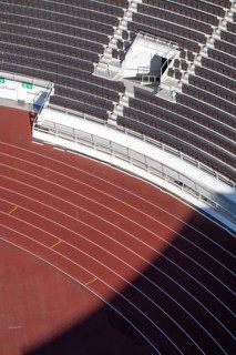 Modern stadium stand with empty seats, outdoor stairs and tartan track, Helsinki Olympic Stadium,