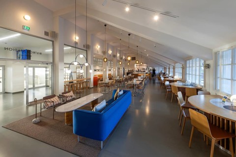 A 1950s style restaurant with seating, tables, large windows and hanging lamps, Olympic Stadium,