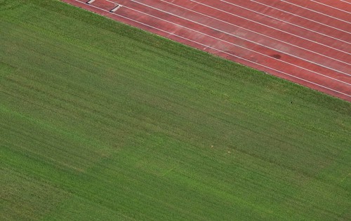 View of well-maintained stadium lawn and tartan track from the Olympic Stadium tower, Helsinki,