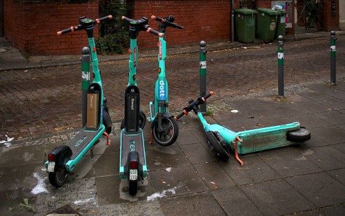E-scooters, electric scooters, scooters parked and carelessly left lying on the side of the road in