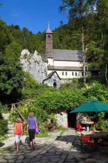 Mother and daughter in front of Maria Klobenstein pilgrimage church, Kössen, Austria