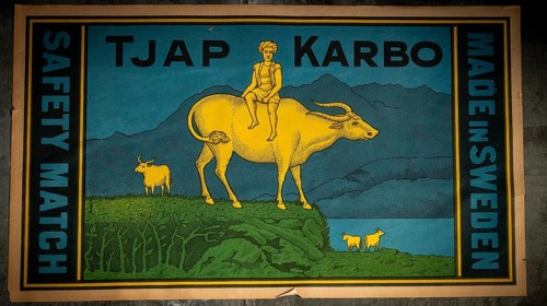 Historic label design, man sitting on water buffalo, Tändsticksmuseet match museum or match museum,