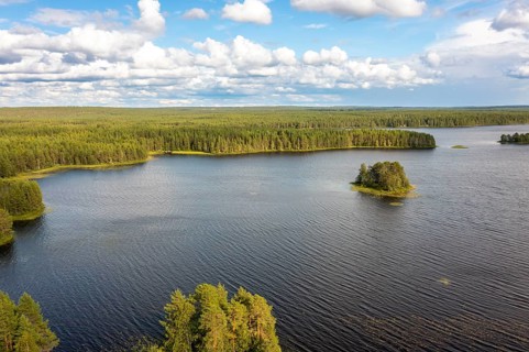 Puolanka, Kainuu, Finland, large lake with small islands and surrounding forest under a cloudy sky