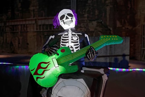 Death plays guitar, illuminated scary figure at Halloween Run, Landschaftspark Duisburg-Nord,