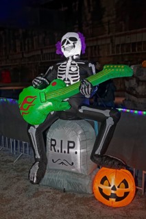 Death plays guitar, illuminated scary figure at Halloween Run, Landschaftspark Duisburg-Nord,