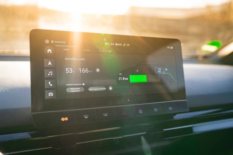 Modern car display provides information about fast charging, embedded in stylish interior, MG4