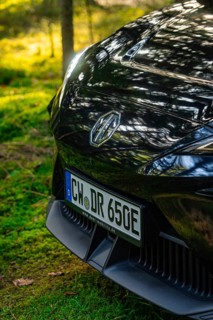 Close-up of a car in a forest clearing in sunlight, MG4 electric car, Deer e-Carsharing, Calw,