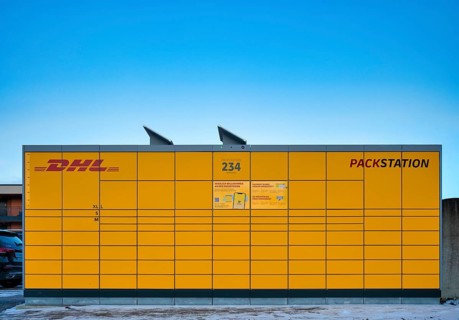 DHL packing station, logo, yellow, with solar cells, solar panels for solar energy supply, sky,