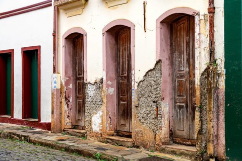 Houses in old colonial architecture with their facades worn by time in the city of Ouro Preto,