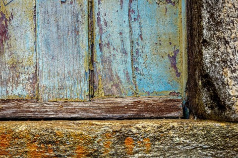 Colors and textures of an old wooden window weathered by time, in the city of Ouro Preto, Ouro