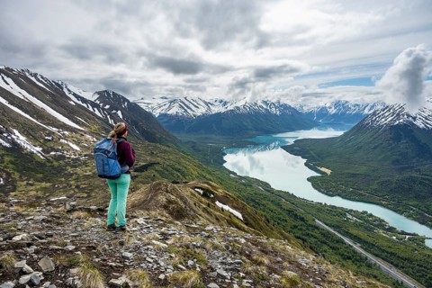 Female mountaineer in front of mountain landscape, Slaughter Ridge Trail, view of snow-covered