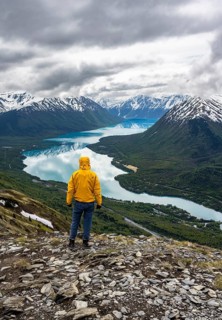 Climber enjoying the view, Slaughter Ridge Trail, view of snowy mountains and turquoise blue Kenai