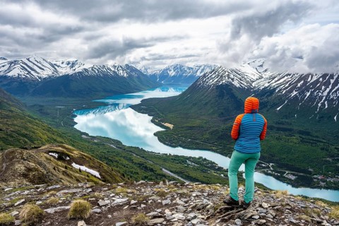 Female mountaineer enjoying the view, Slaughter Ridge Trail, view of snowy mountains and turquoise