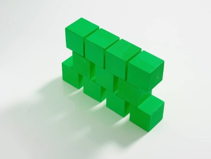 11 green wooden cubes against a white background