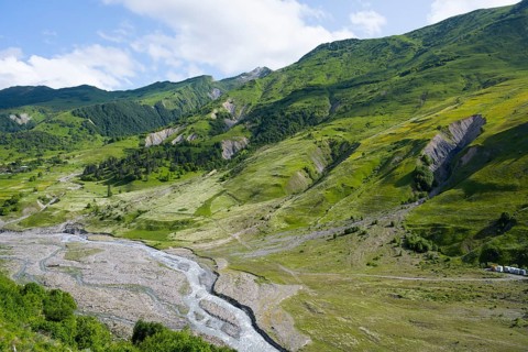 Scrambled landscape with green slopes and small rivers, landscape between Kvesheti and Gudauri,