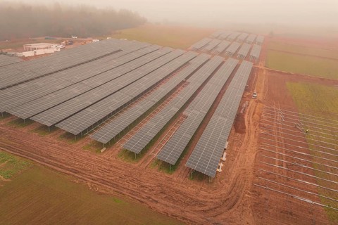 Solar fields under fog, sustainable energy in a wide field landscape, energy revolution,