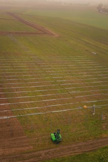 Prepared fields for solar plant construction, green environment, machine operation for