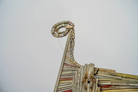 Close-up of an artfully designed wooden Viking dragon head, sculpture by Drakkar Vardø. The