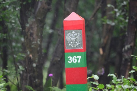 A colorful border post border marker on the Jacobselv river on the Russian side of the