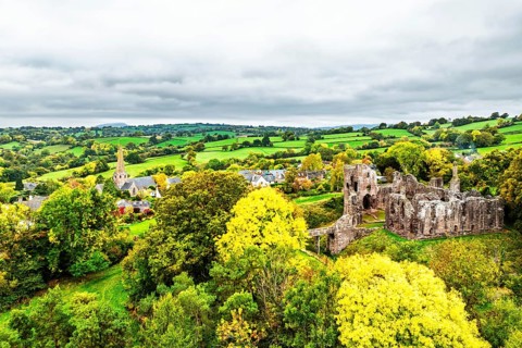 Autumn Colours over ruins of Grosmont Castle from a drone, Grosmont, Monmouthshire, Wales, UK