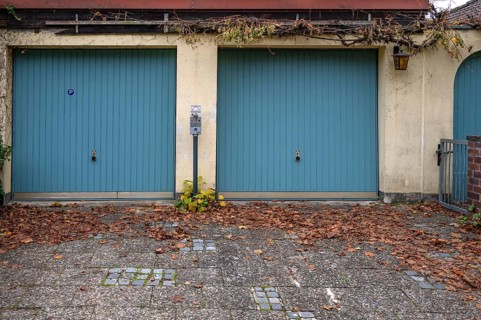Parking meter between two garages, Bavaria, Germany