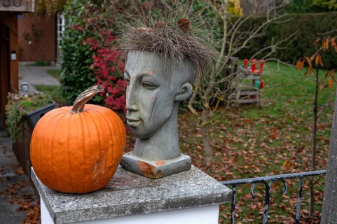 Head of a figure and a pumpkin on a garden wall, Franconia, BNayern, Germany